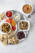 Chickpea salad, olives, hummus, tomatoes and grilled pita bread