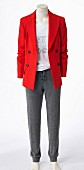 A red blazer, a white shirt and grey trousers on a headless mannequin