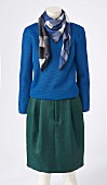 A blue jumper, a checked scarf and a midi skirt on a headless mannequin