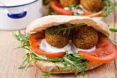 Unleavened bread filled with falafel, tomatoes and rocket