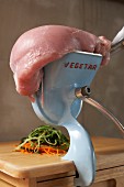 A piece of meat on top of a vegetable chopper