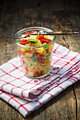 Pasta salad with colourful vegetables in a glass