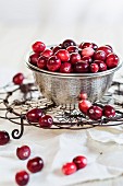 Cranberries in a metal bowl on a cooling rack