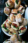 Mini sandwiches with dried tomatoes, aubergines and lettuce