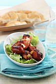 Sausage skewers on a bed of lettuce