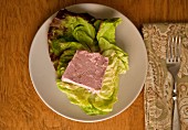 Cream cheese, cranberry and pecan nut terrine on a lettuce leaf