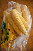 Corn cobs from a farmer's market in a plastic bag