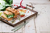Spring rolls with vegetables and prawns served with a spicy sauce on a tray