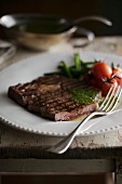 Grilled rib-eye steak with a herb sauce