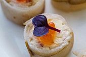 Spicy rolls with fish, salmon caviar and decorative flowers
