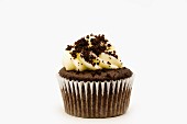 A chocolate cupcake decorated with chocolate biscuit crumbs