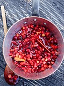 Pear and cranberry compote in a saucepan