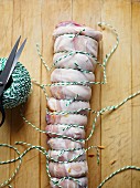 Suckling pig roulade being tied
