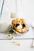 A blueberry and yoghurt muffin with oats next bottle of milk