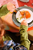 A boy eating a salmon dish for Christmas