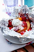 Grilled fruit with marshmallows in aluminium foil