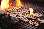 Chicken fillets on flaming a charcoal grill