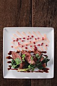 Roasted duck breast with spring onions, spinach and pomegranate seeds