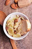 Cabbage soup with almonds, pine nuts and a slice of white bread