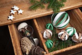 DIY-Dekobälle aus Papierstreifen und gewickelte Seile in hellen Brauntönen, weihnachtlich arrangiert mit Tannenzweigen und Zimtsternen
