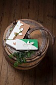 DIY gift boxes tied with ribbons on old wooden barrel