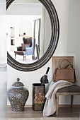 Upholstered chair, umbrella stand, floor vase and oval vase in hallway