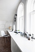 White desk against gable wall with arched windows