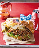 A pulled pork sandwich with cola