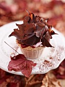 An autumnal cupcake with cranberry cream and cranberry purée