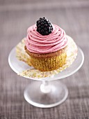 A pistachio and blackberry cupcake