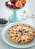 A frangipane tart with nectarines and blueberries