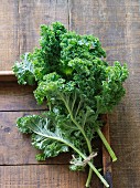 Fresh green kale leaves on a wooden surface