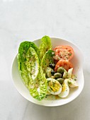 Cost lettuce with egg, olives, tomatoes and lettuce