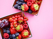 Fresh summer berries and fruits in small dishes