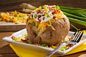 A twice baked potato with Cheddar cheese, onions, sour cream and bacon