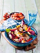 Sweet-and-sour pork skewers with red onions and peppers