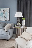 Upholstered furniture and table lamp on side table in living room