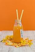 Freshly pressed orange juice in a glass bottle