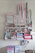 Collection of patterned pastel fabrics and trims on old wall-mounted shelving