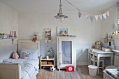Pale blue walls and shabby-chic furniture in boy's bedroom