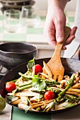 Fried asparagus with tomatoes and basil