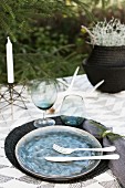 A winter table laid outside in shades of white and grey