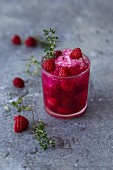 A raspberry cocktail with vodka, fresh thyme and crushed ice
