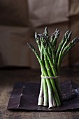 A bunch of green asparagus on a rustic surface