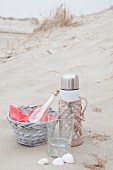 Beach picnic with thermos flask in pink crocheted cover