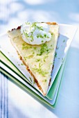 A slice of cheesecake with lime zest