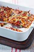 Enchiladas with beef, tomato sauce, cheese and coriander