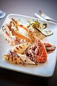 A grill platter featuring squid, prawns and langoustines