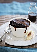 Chocolate soufflé with chocolate sauce and whipped cream