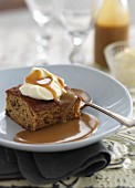 Date cake with caramel sauce and cream